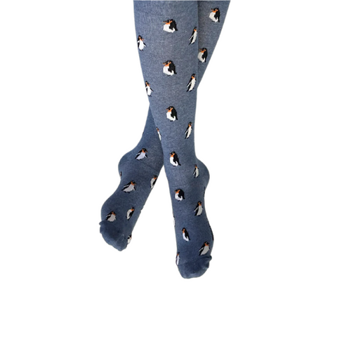 A pair of blue compression socks with a penguin pattern, displayed in a standing position.